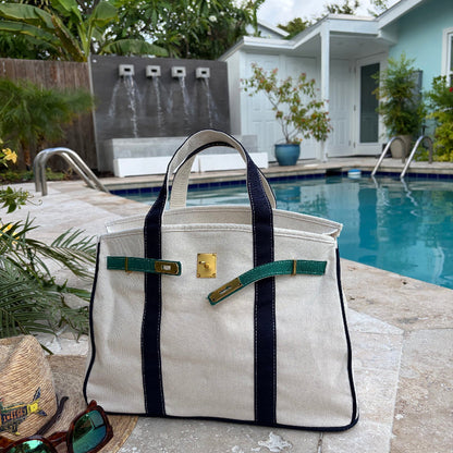 Navy and green Boatkin bag open by a pool.