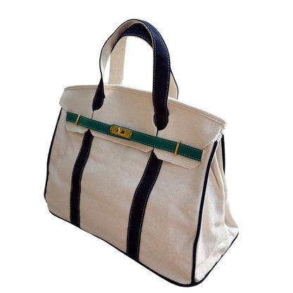 Navy and green Boatkin bag piping on a white background.
