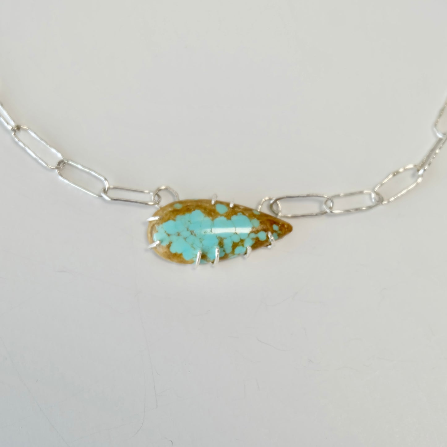 Close-up of the Number 8 turquoise cabochon showcasing its vivid blue-green color and unique matrix.