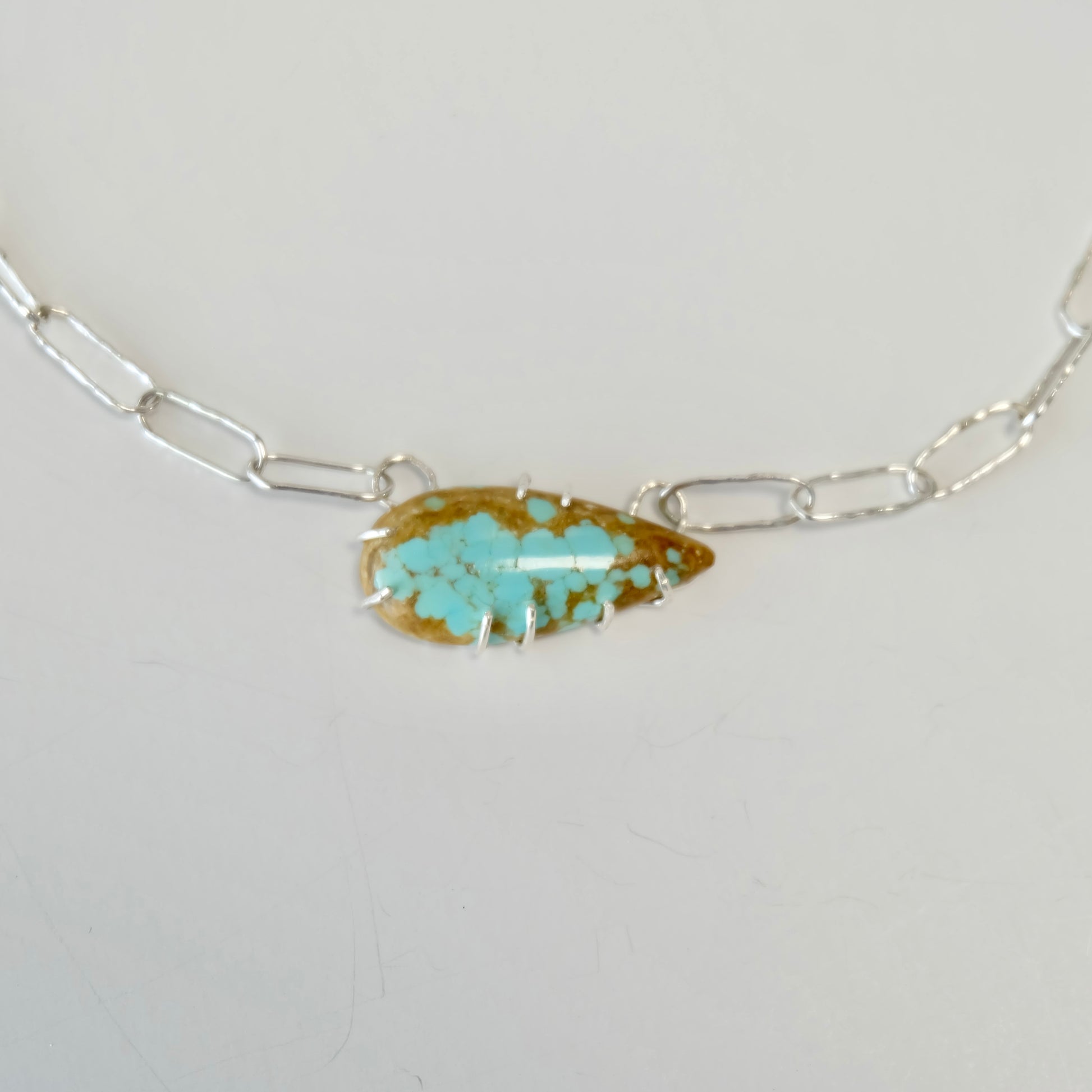 Close-up of the Number 8 turquoise cabochon showcasing its vivid blue-green color and unique matrix.