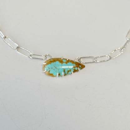 Close-up of the Number 8 turquoise cabochon showcasing its vivid blue-green color and unique matrix.