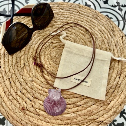 One-of-a-kind purple fan shell necklace with rose quartz on woven mat