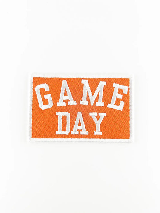 Embroidered patch with 'GAME DAY' text on an orange background