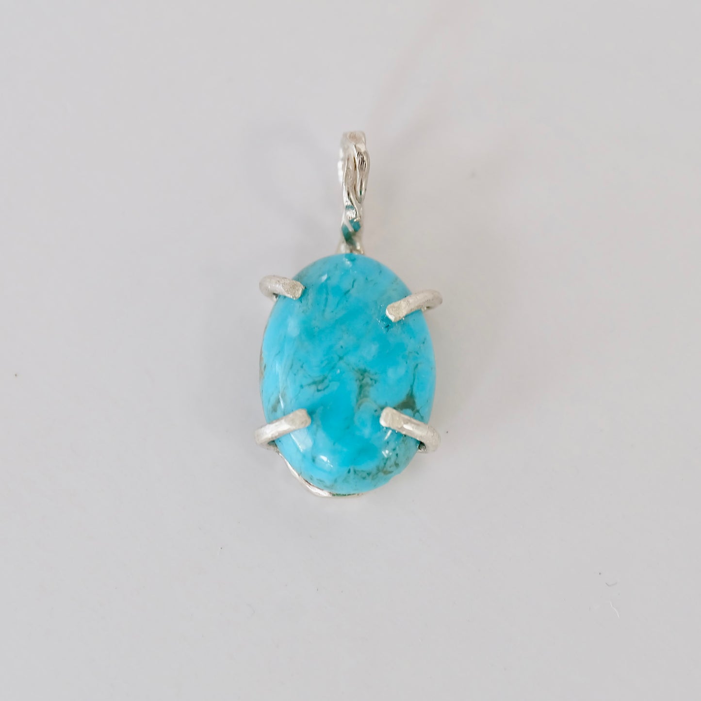 Elegant turquoise charm, handcrafted from sterling silver with vibrant Kingman turquoise, ideal for any special occasion.