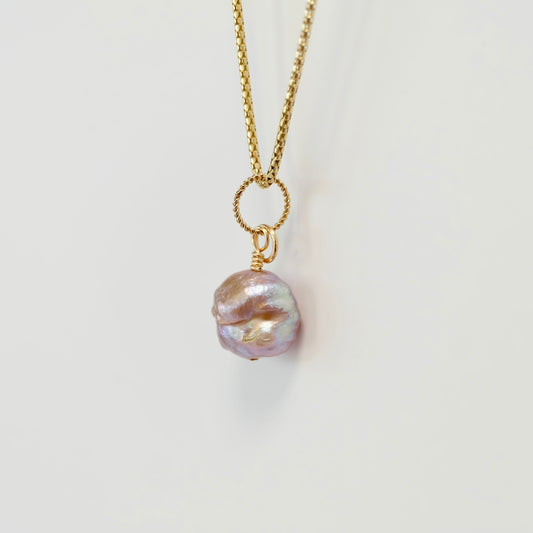 Handcrafted freshwater pearl charm on 14k gold-filled wire, showcasing elegance and natural beauty in a delicate design.