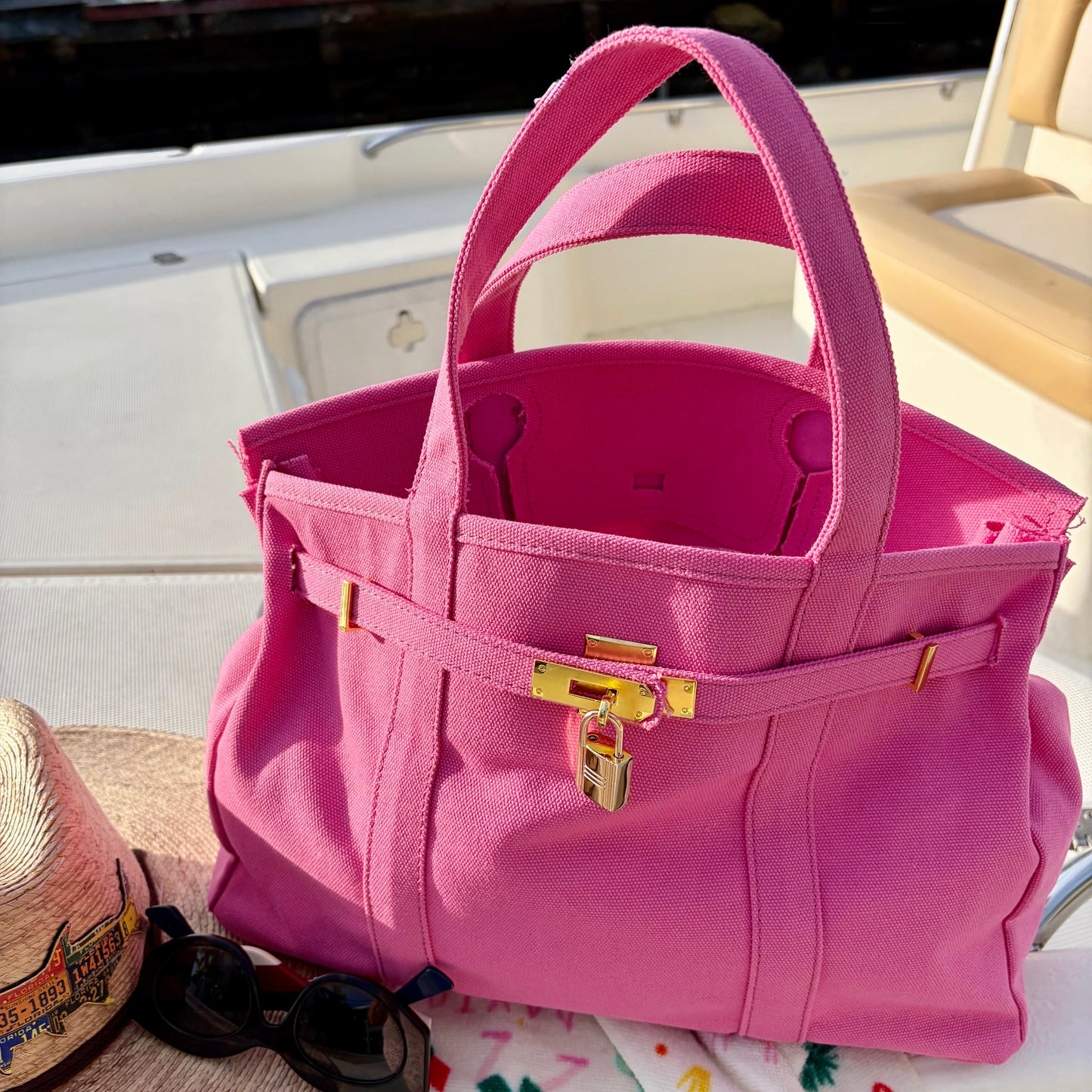 Pink Boatkin interior with gold accents on a boat deck