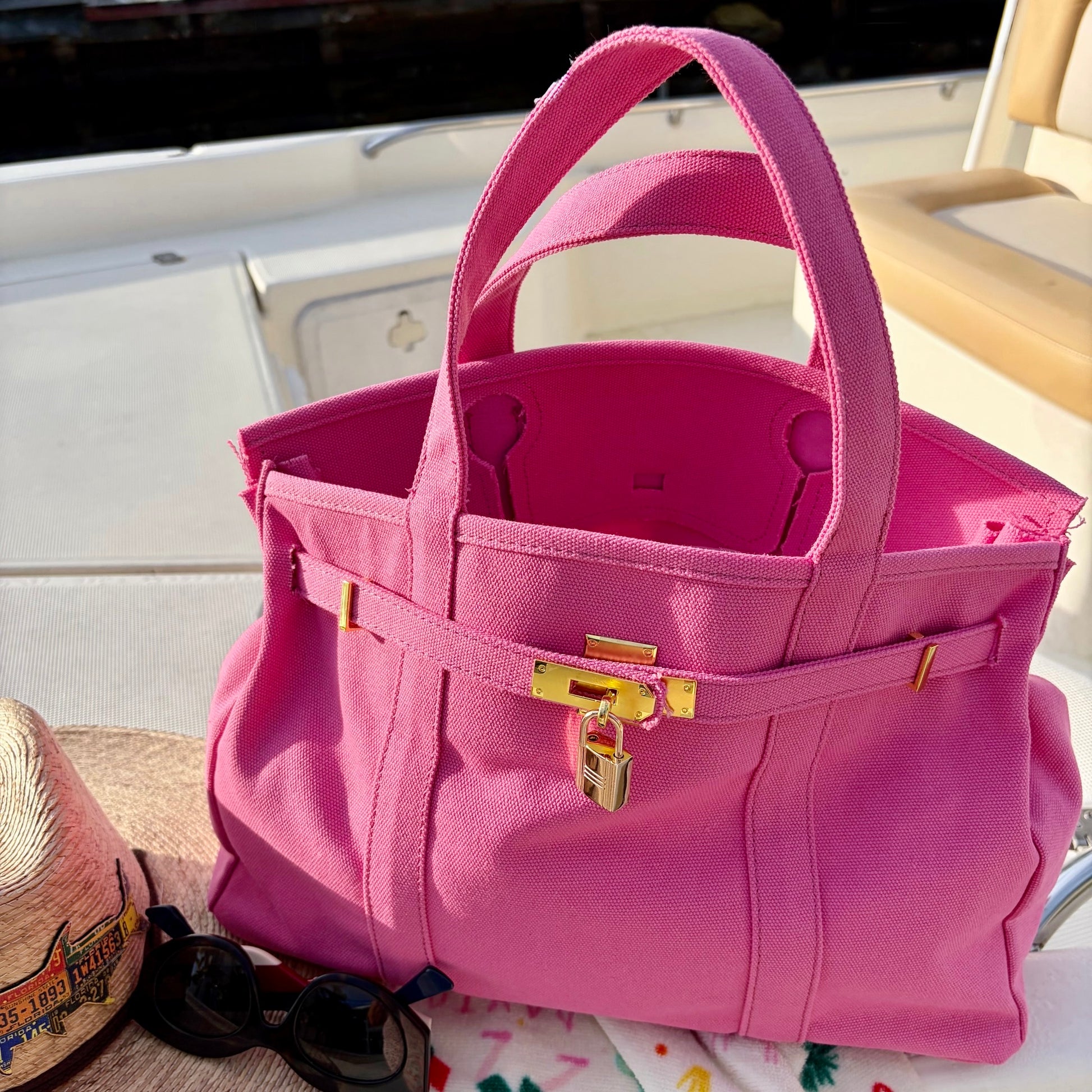 Pink Boatkin interior with gold accents on a boat deck