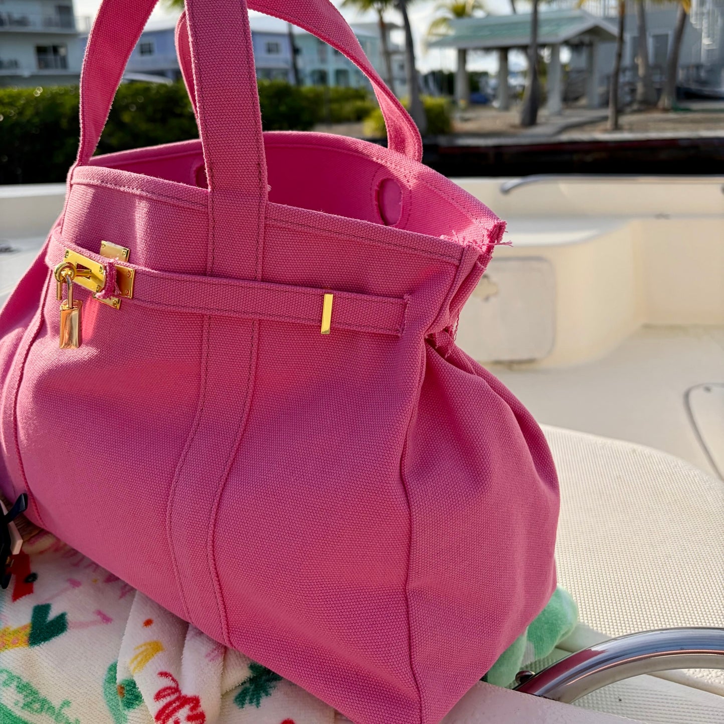 Pink Boatkin side view with gold clasp on a boat