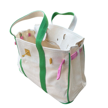 Pink and green Boatkin bag open showing roomy interior and gold hardware on a white background