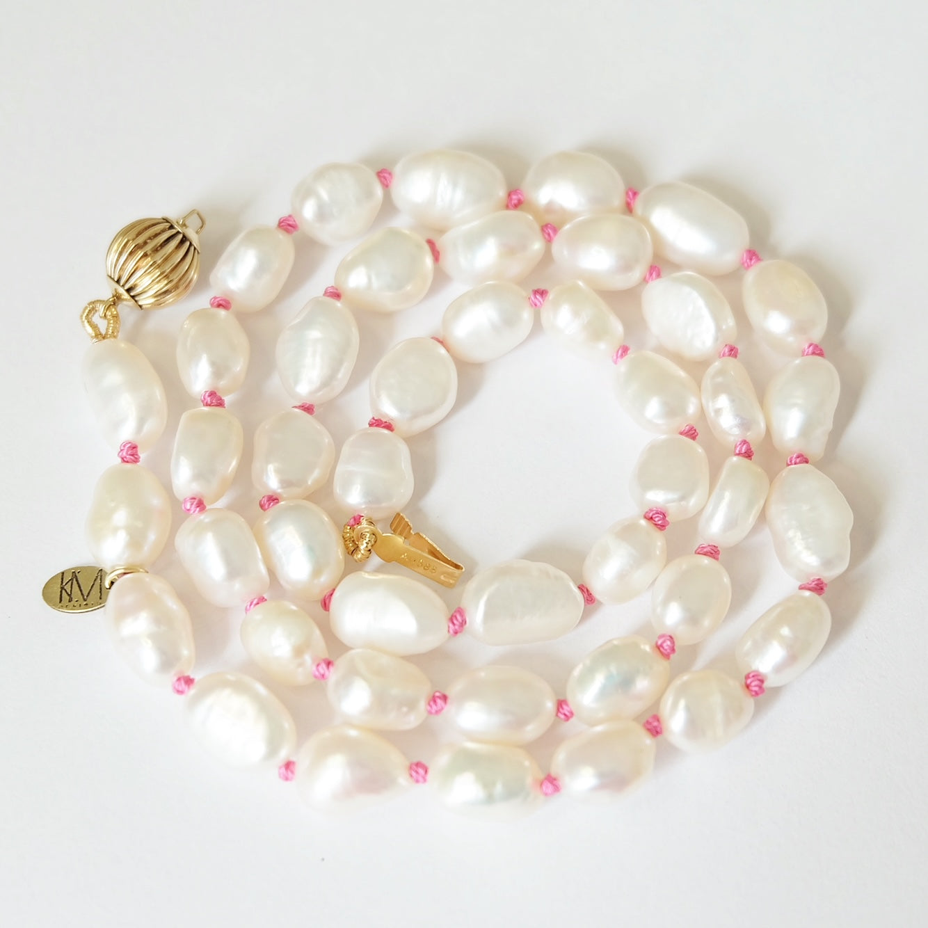 Close-up of pink pearls and gold clasp