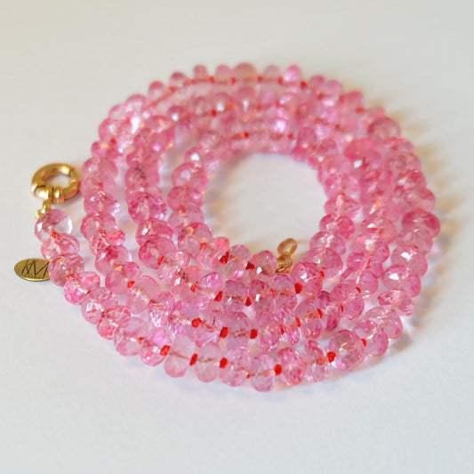 Faceted pink topaz beads hand-knotted on pink, orange, and yellow silk