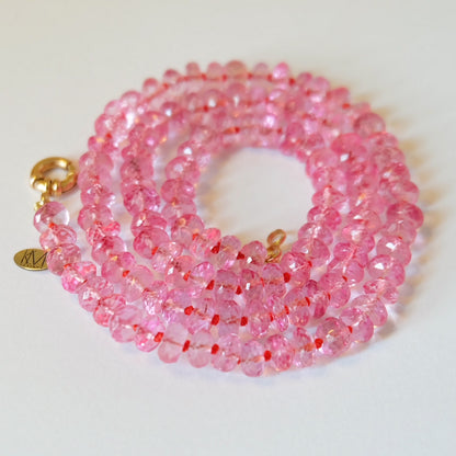 Faceted pink topaz beads hand-knotted on pink, orange, and yellow silk