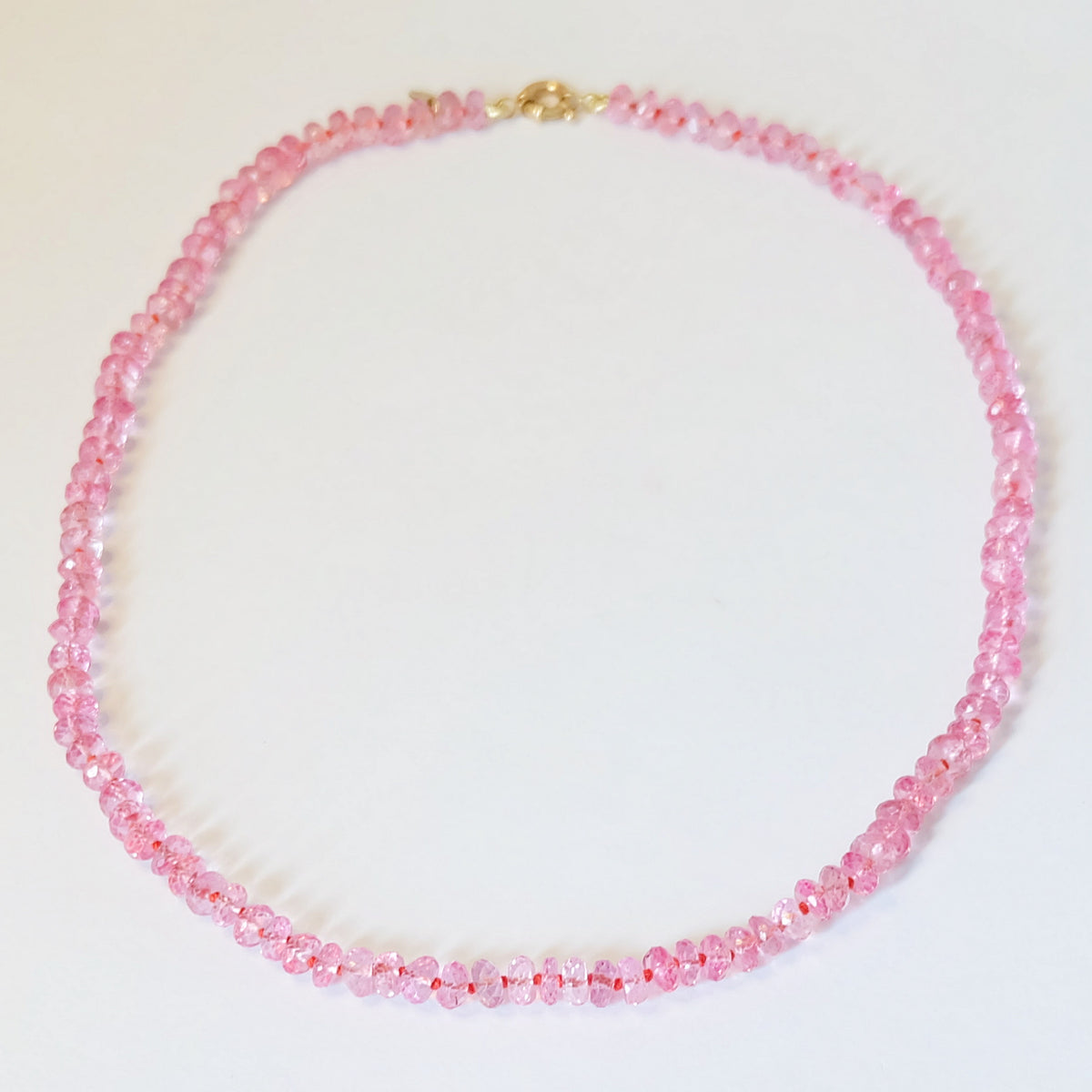 Full strand of a pink topaz beaded candy necklace in 14K gold