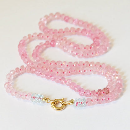 Close-up of pink tourmaline beads and aqua blue topaz accents with a 14K gold clasp