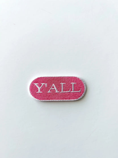 Pink Y'all iron-on patch for layering with other patches on a tote