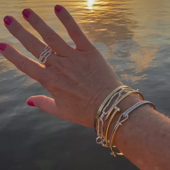 Elegant sterling silver paperclip bracelet featuring a unique braided design, perfect for adding a touch of sophistication to any outfit.