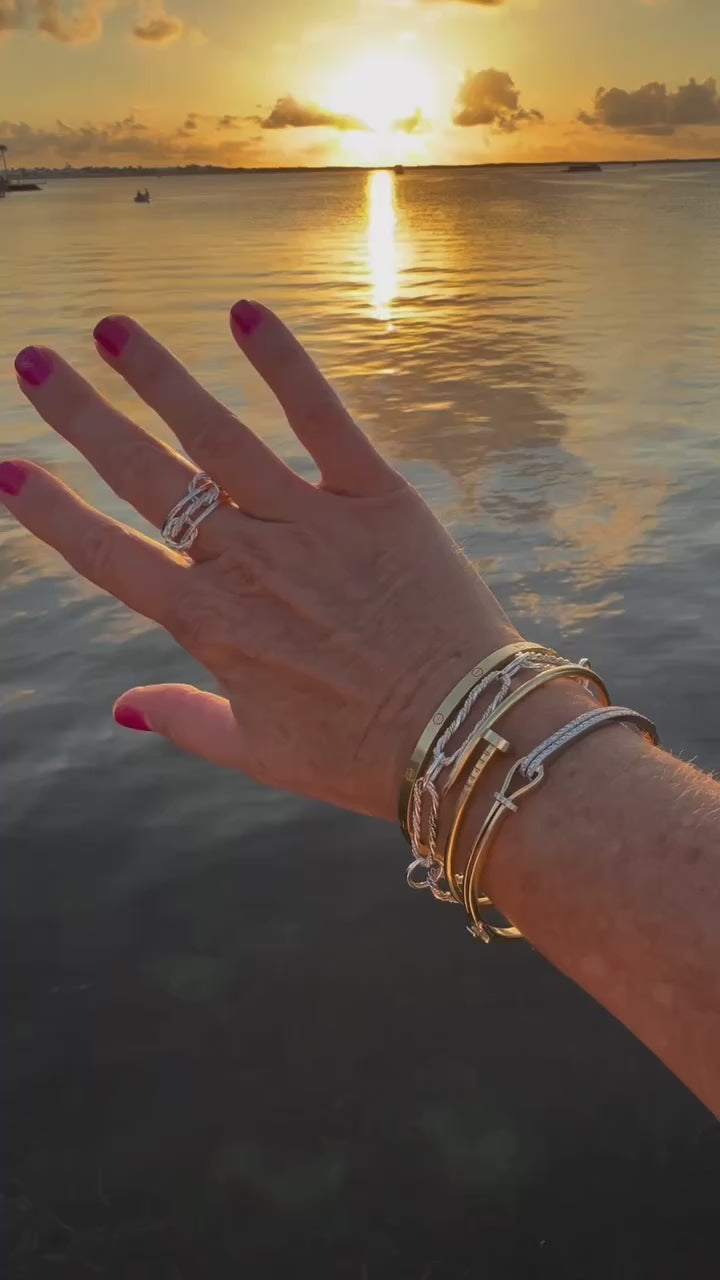 Elegant sterling silver paperclip bracelet featuring a unique braided design, perfect for adding a touch of sophistication to any outfit.