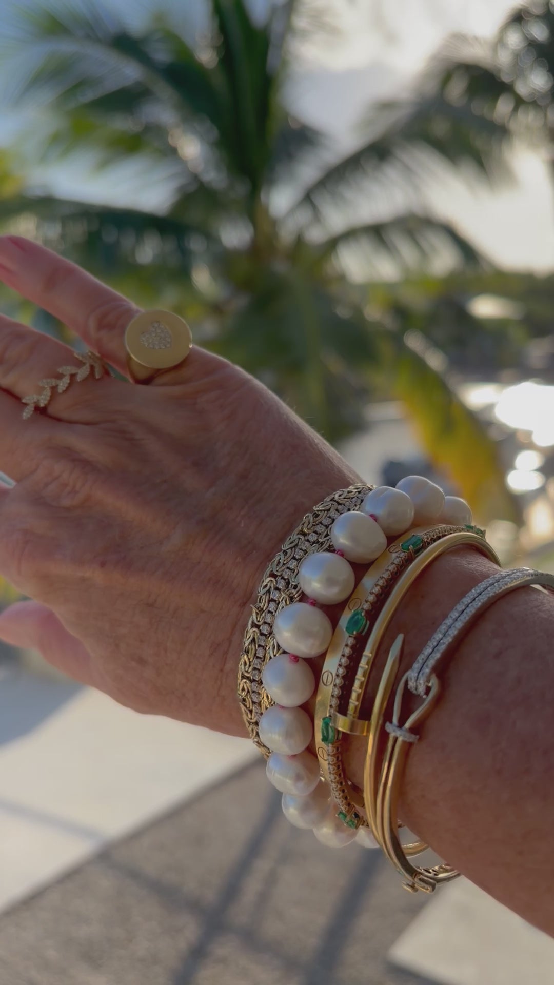 Elegant potato pearl bracelet with pink silk knots, a sterling silver clasp, and a dangling pink topaz and pearl charm.