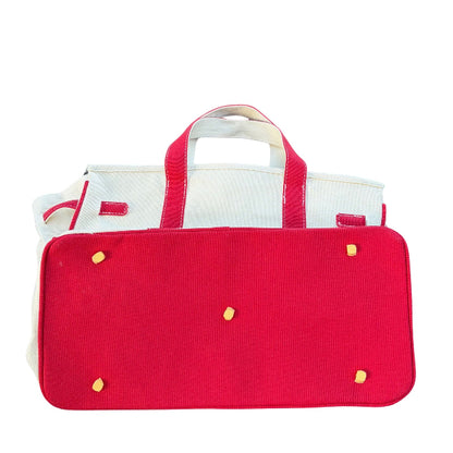 Red Boatkin bag bottom showing gold feet on a white background