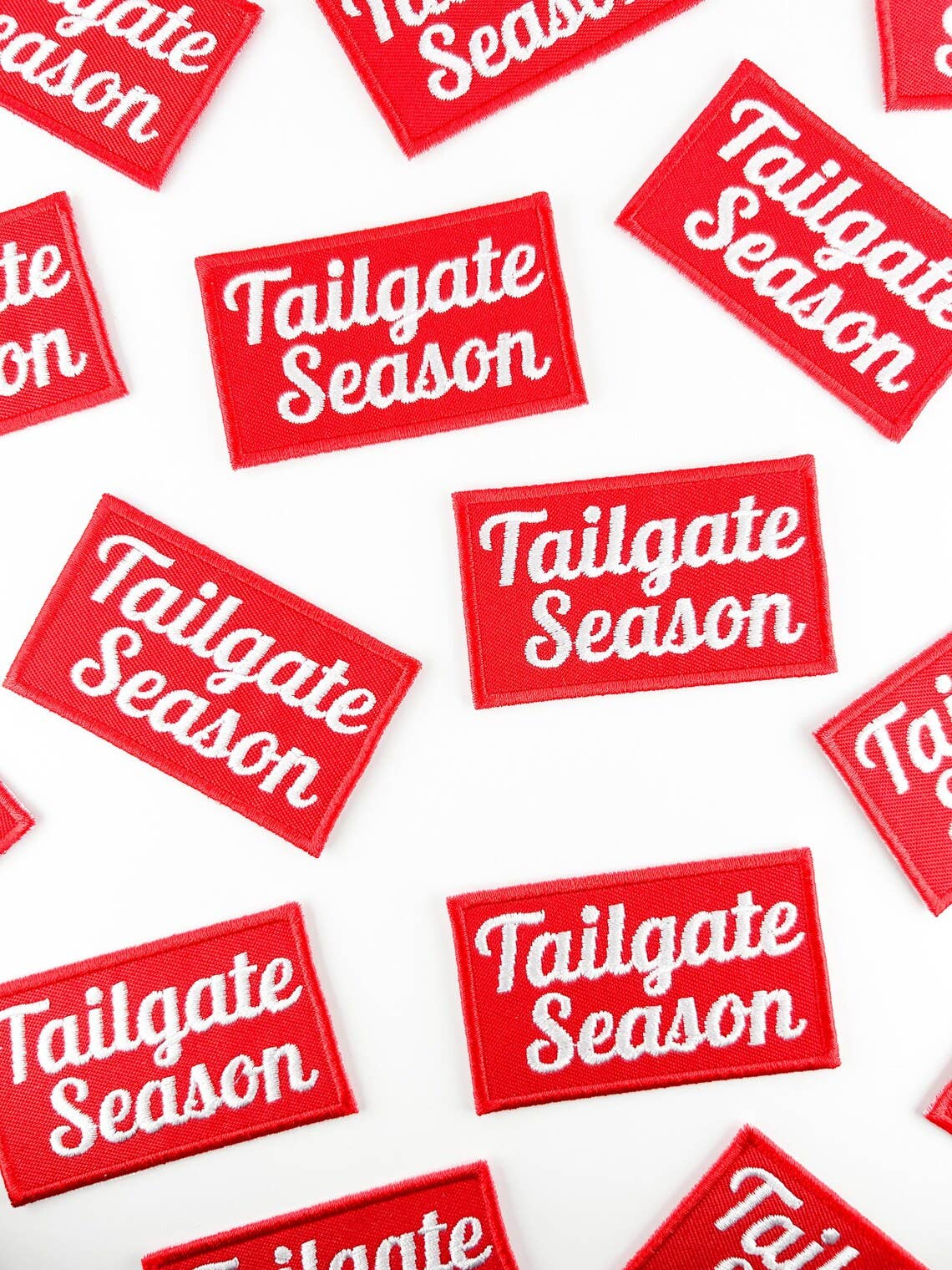 Red and white 'Tailgate Season' patches on a white background