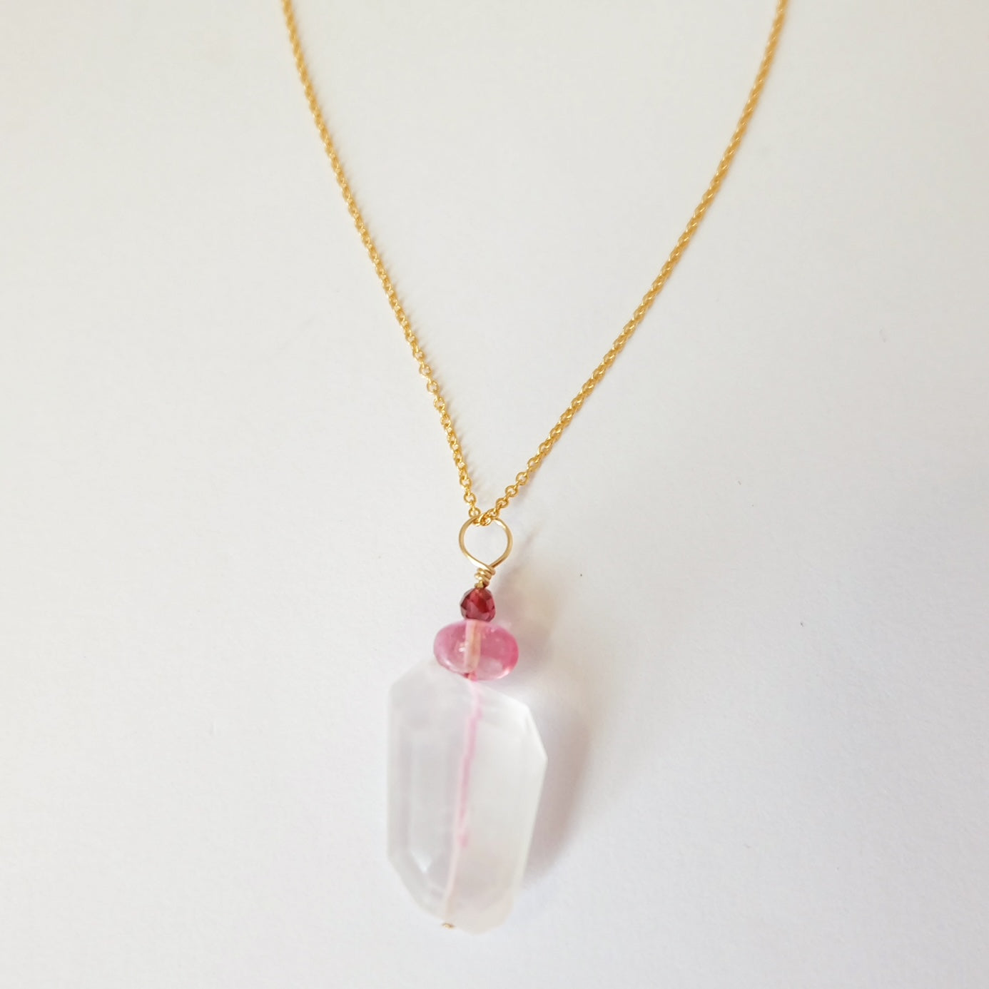 Rose quartz, pink topaz, and garnet charm necklace on a 14K gold-filled chain