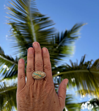 Woman's hand wearing a Royston ribbon turquoise ring in 14k gold and sterling silver