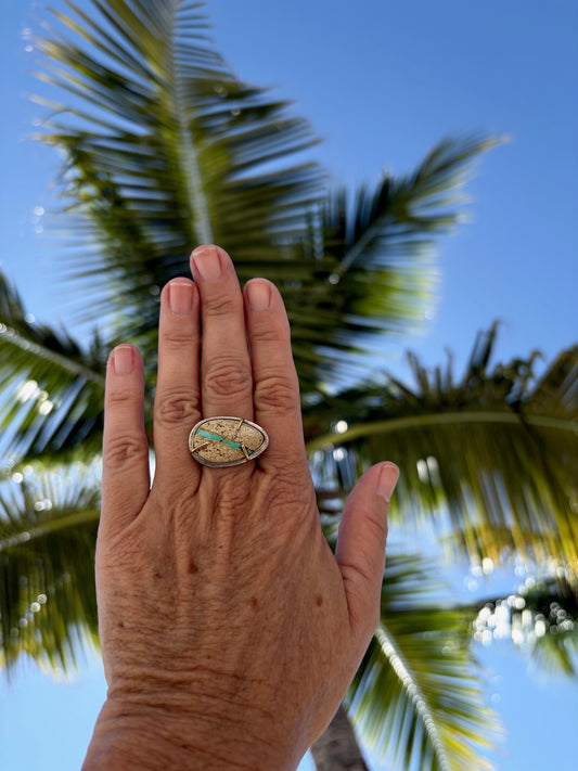 Woman's hand wearing a Royston ribbon turquoise ring in 14k gold and sterling silver