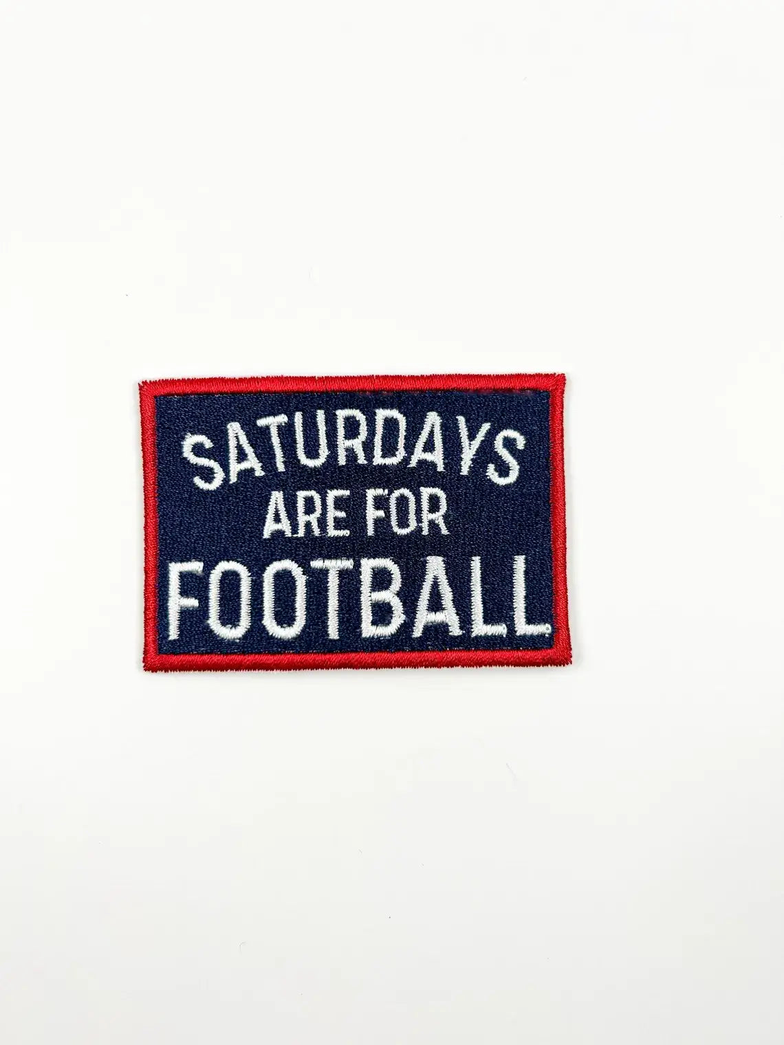 A rectangular embroidered patch with a navy blue background, red border, and white text reading 'SATURDAYS ARE FOR FOOTBALL' on a plain white background.