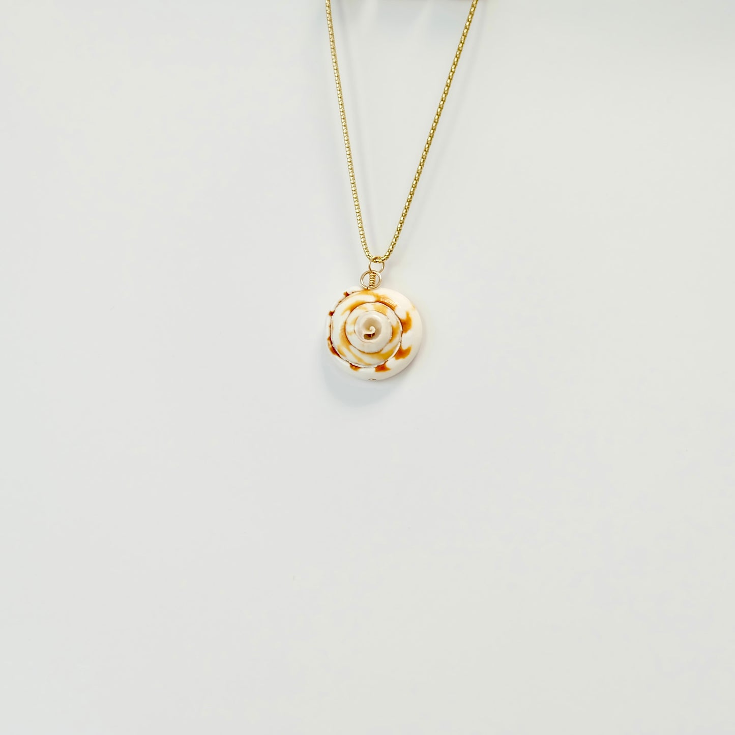 Beautiful sea shell charm made from 14k gold-filled wire, featuring a spring clasp for versatile necklace styling.