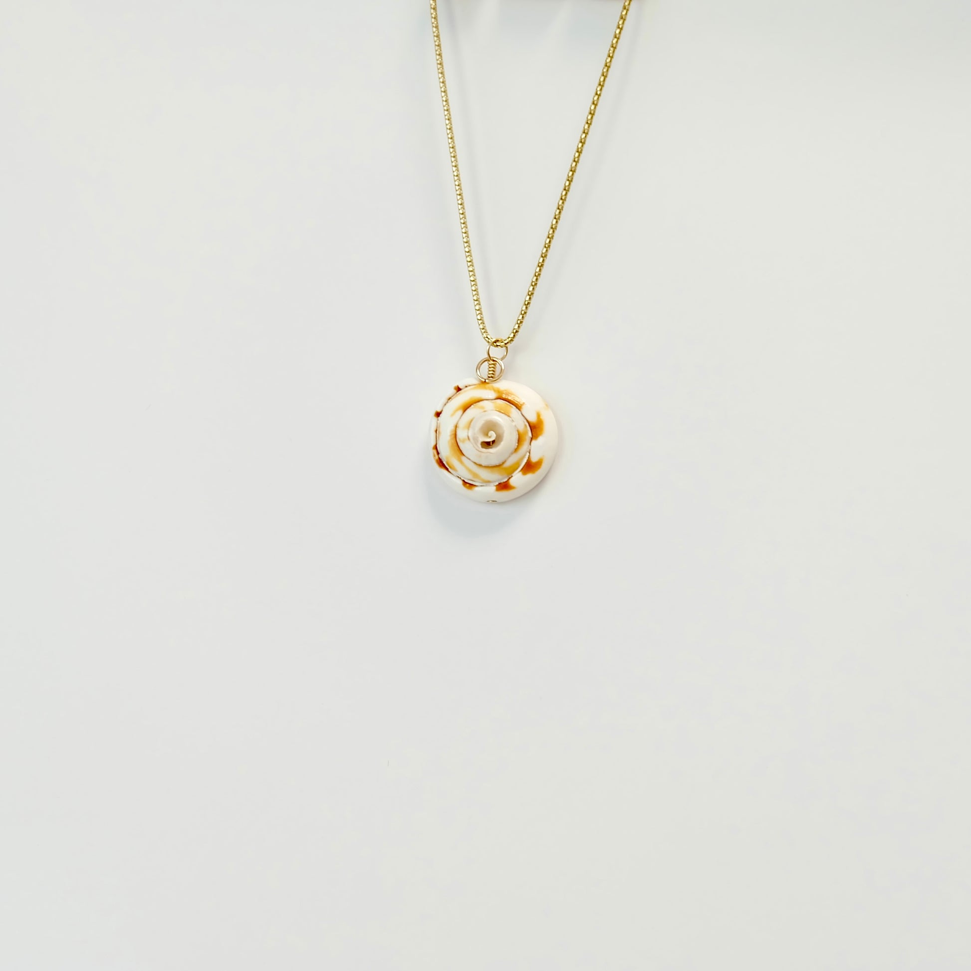 Beautiful sea shell charm made from 14k gold-filled wire, featuring a spring clasp for versatile necklace styling.