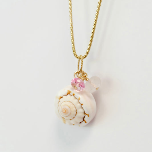 A delicate charm featuring sea shell pink topaz and rose quartz, perfect for adding a touch of elegance to any jewelry piece.