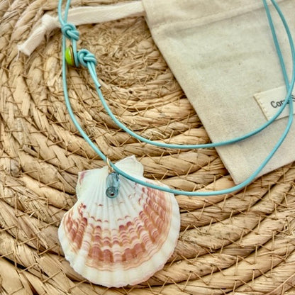 Shell choker close-up with aquamarine and neon apatite on turquoise cord