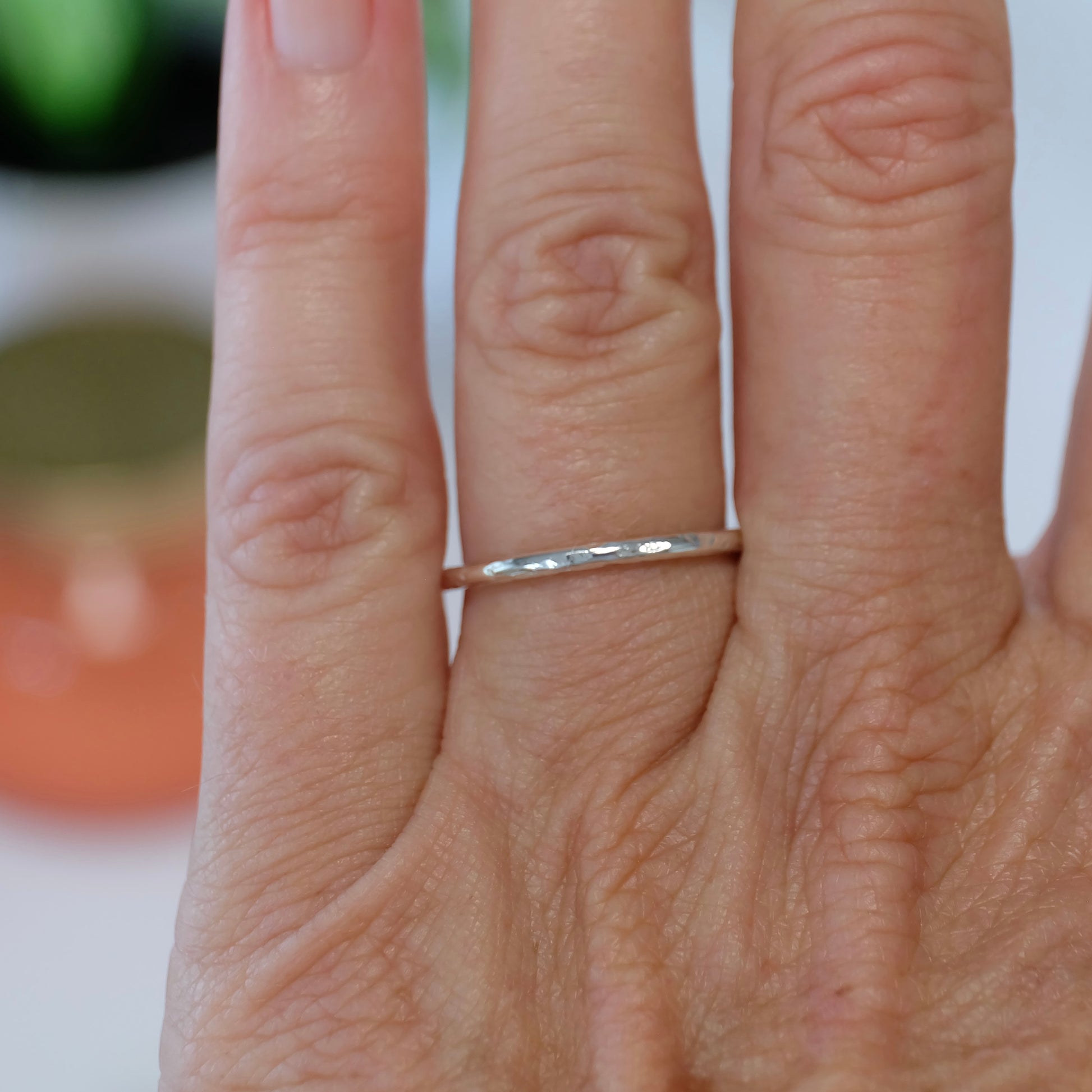 A delicate sterling silver stacking ring, showcasing a sleek design perfect for layering with other rings.