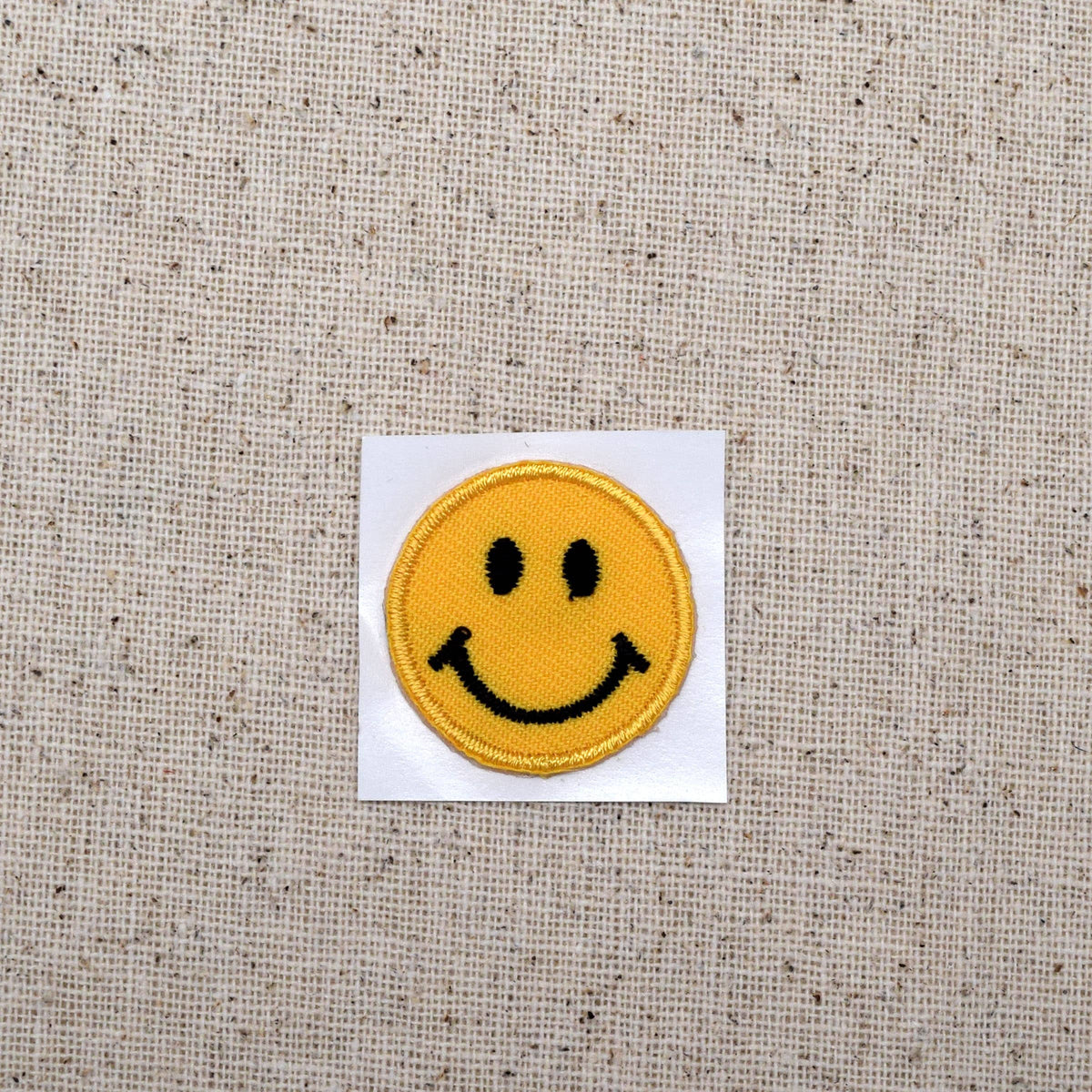 Small smiley face embroidered iron-on patch, view 3