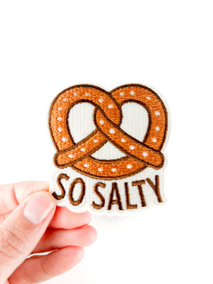So Salty embroidered iron-on patch shaped like a pretzel