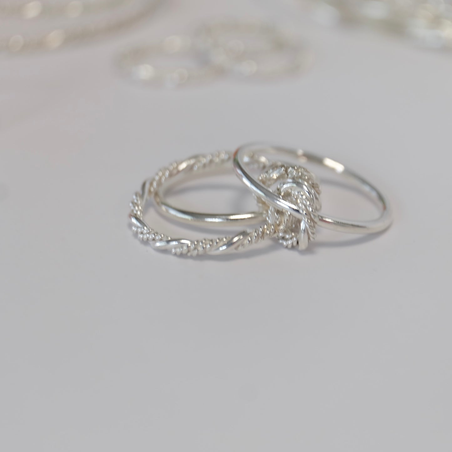 The Solarium ring features three elegant bands and connectors, allowing for versatile styling on one finger or multiple fingers.