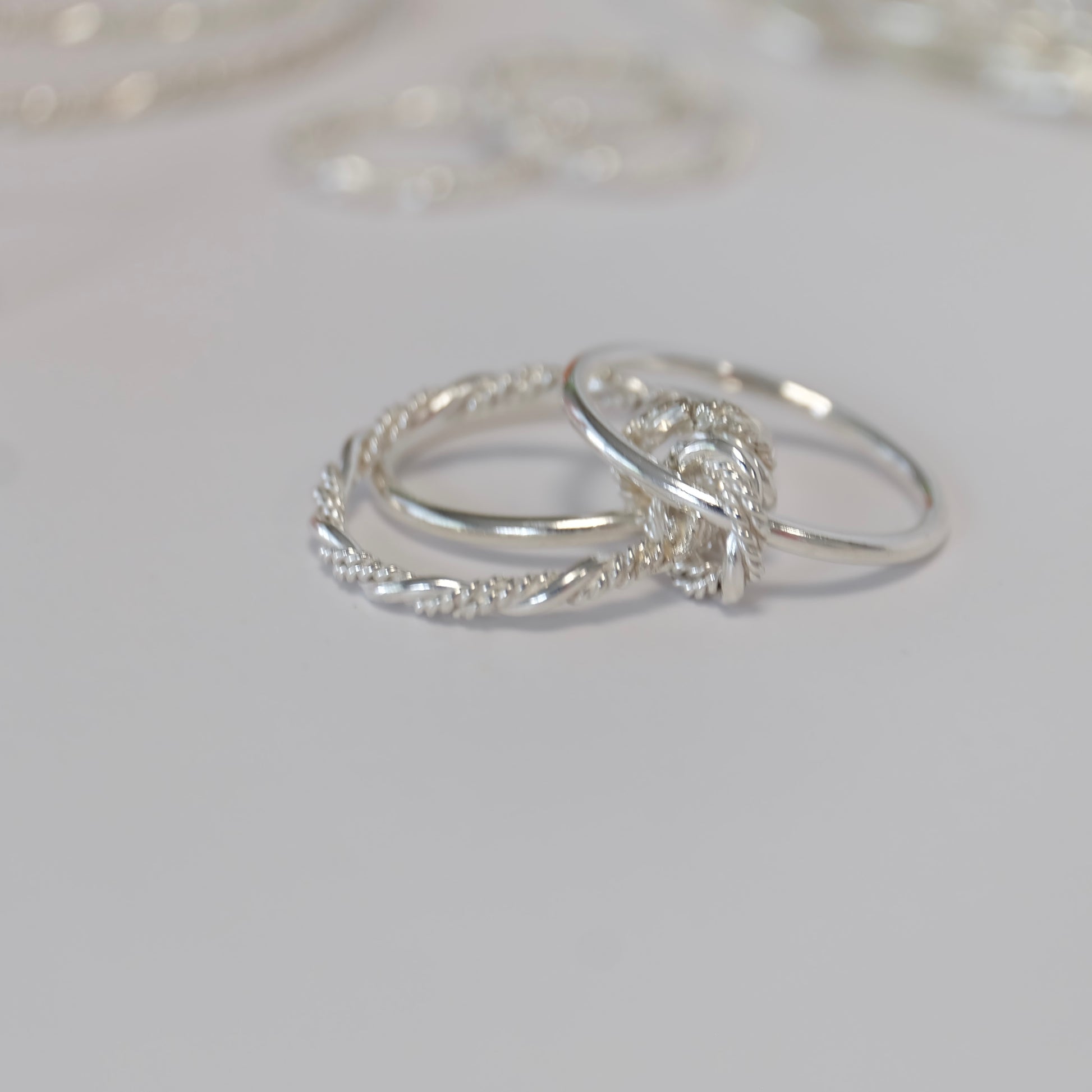 The Solarium ring features three elegant bands and connectors, allowing for versatile styling on one finger or multiple fingers.