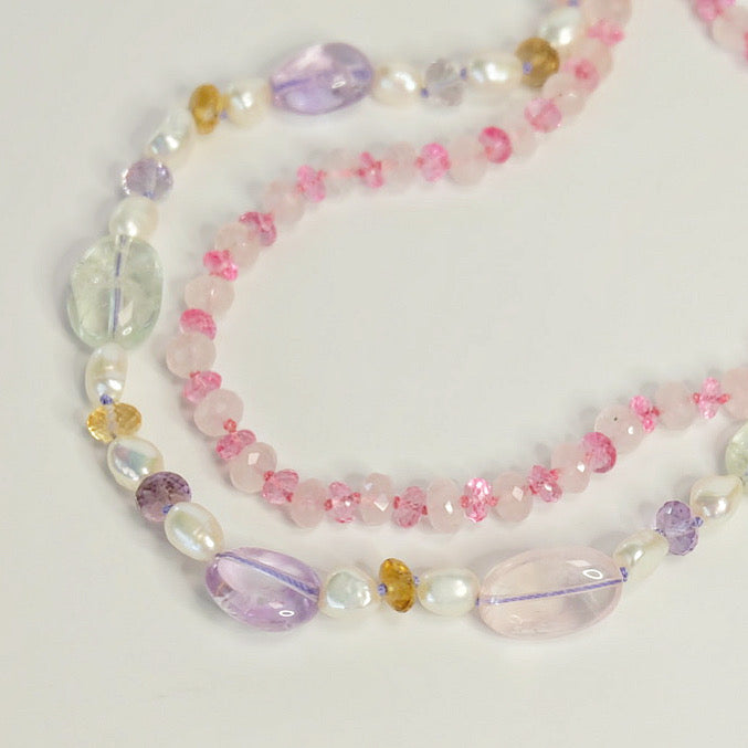 Close up of stacked gemstone necklaces