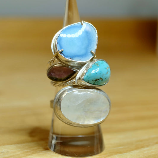 Stacked sterling silver rings in a variety of styles and textures