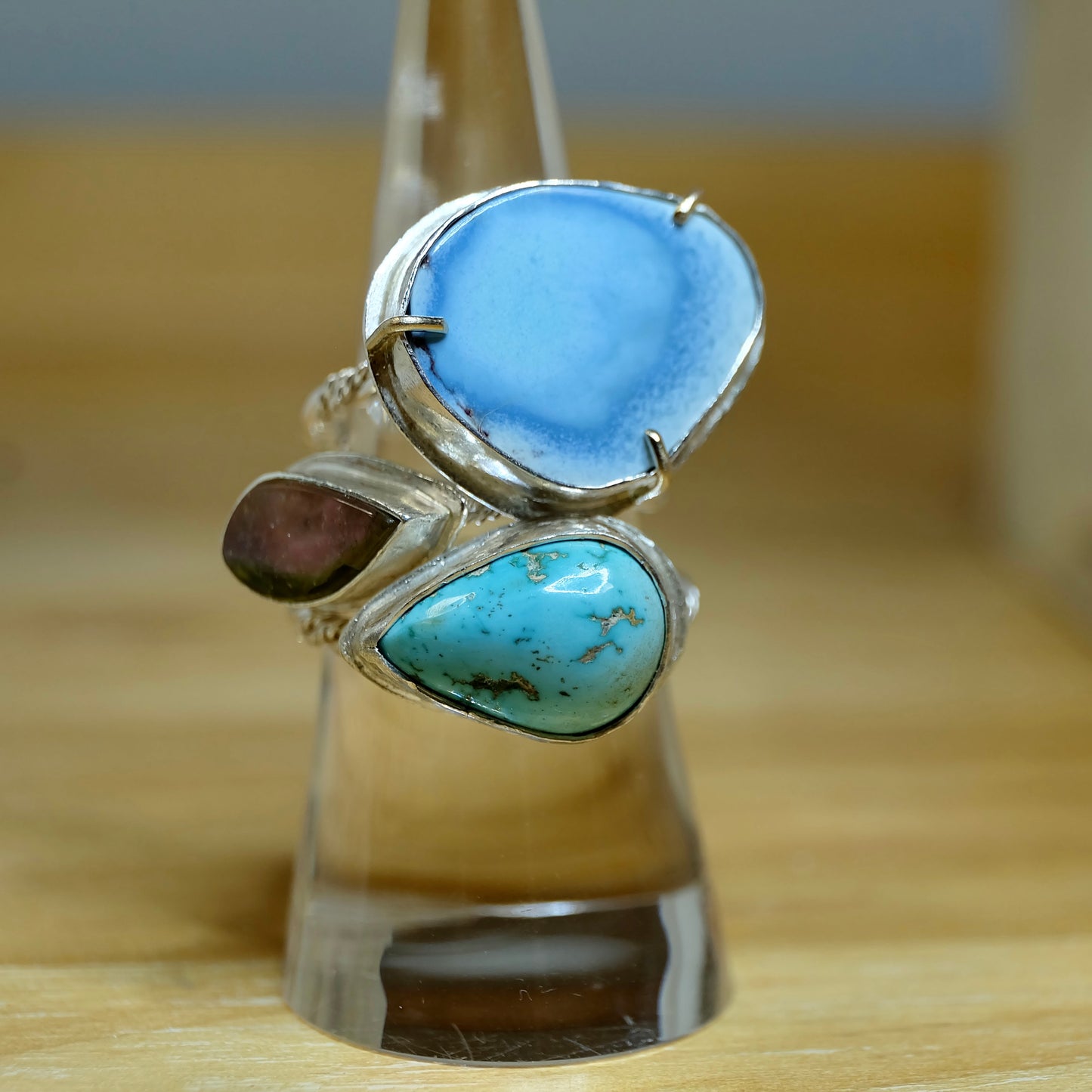 A collection of sterling silver turquoise rings artistically arranged, showcasing vibrant blue hues and unique patterns.