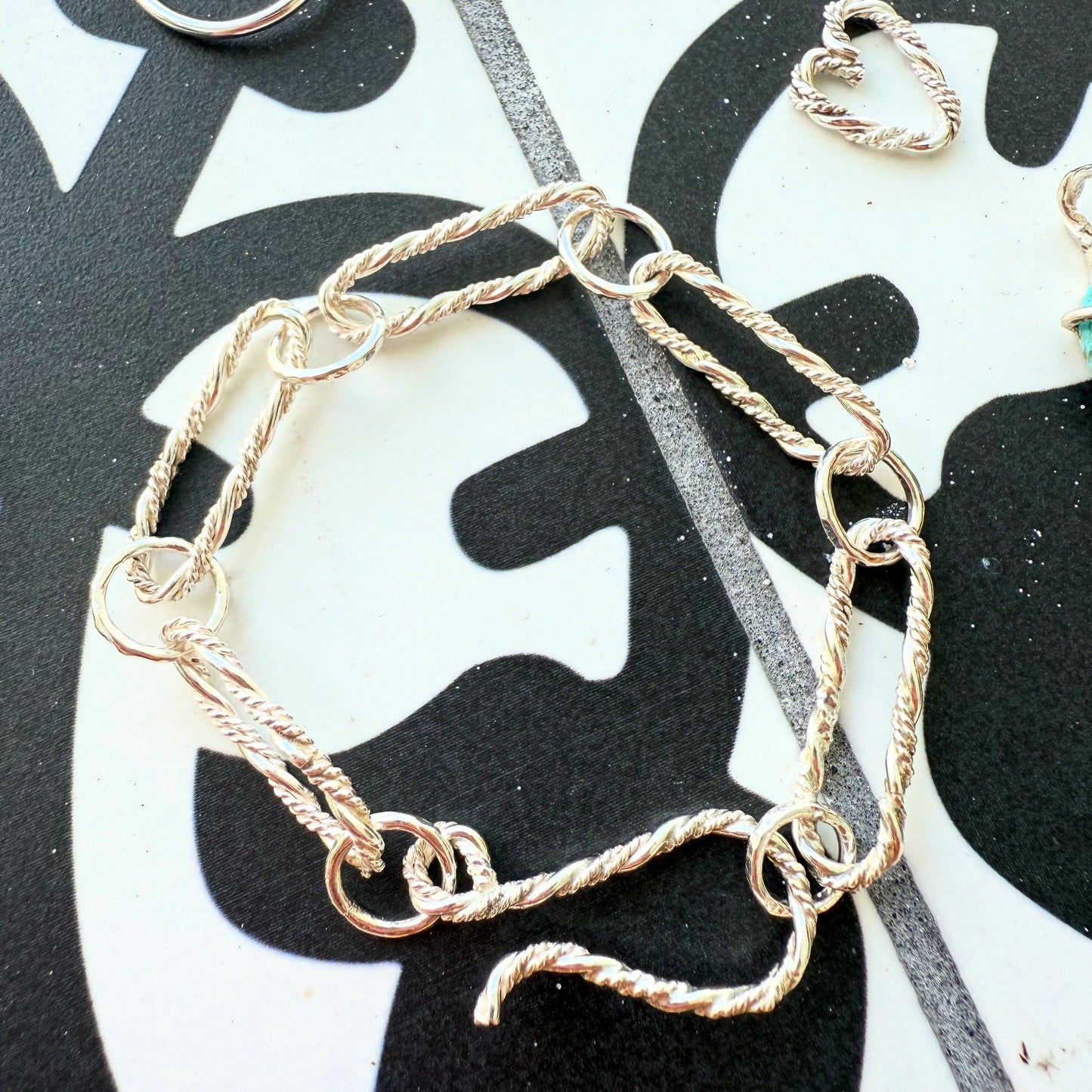 A sleek sterling silver paperclip bracelet featuring elongated links for a modern and elegant look.
