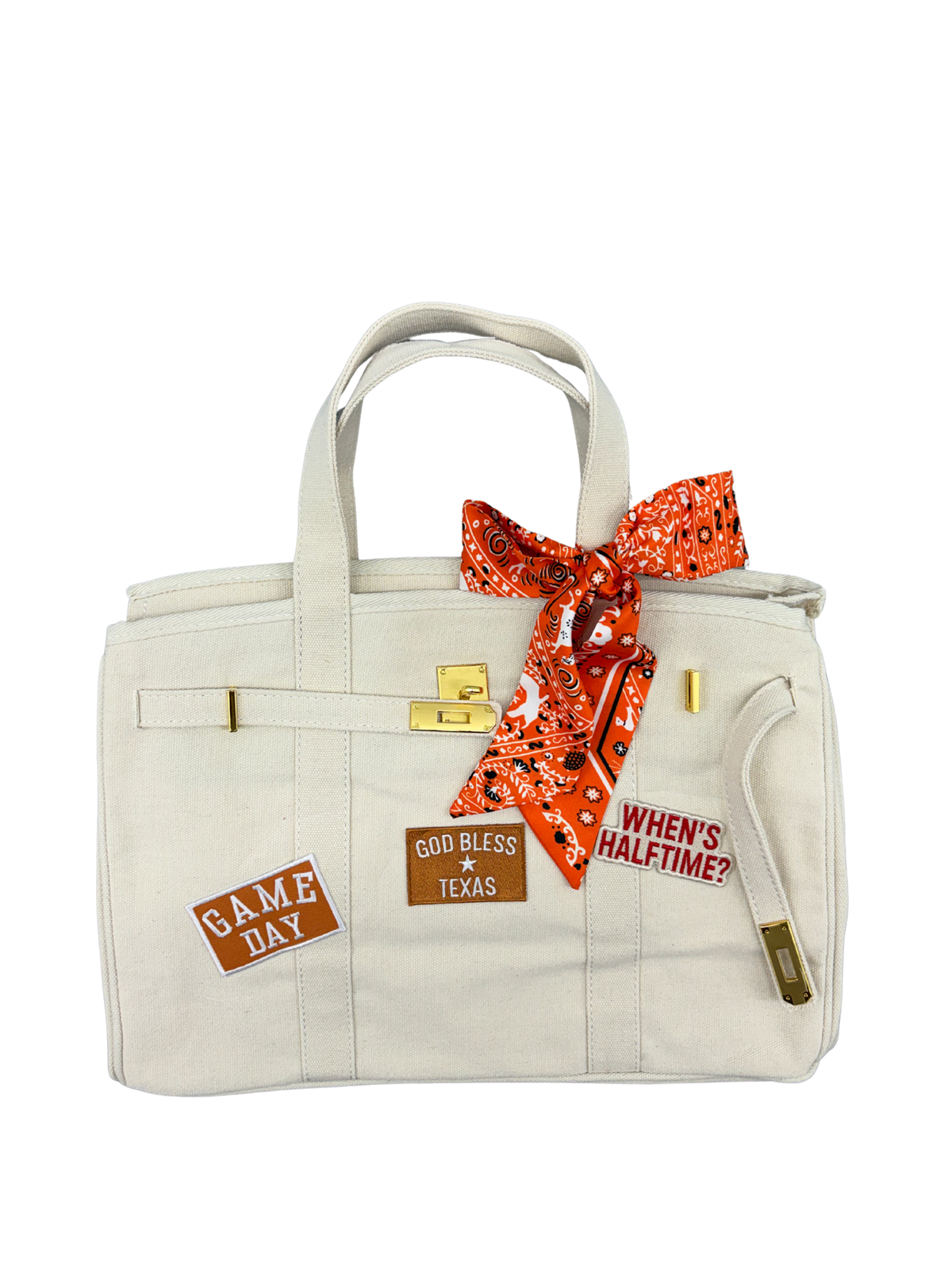 Ccream winter white Texas Longhorns college football tote bag featuring a bright orange bandana print twilly scarf tied to the handle and game day iron on patches.
