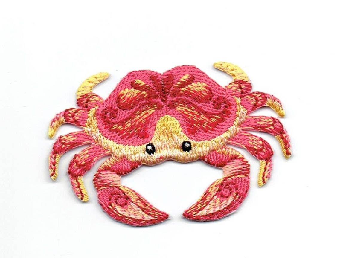Tropical crab embroidered iron-on patch in coral and yellow