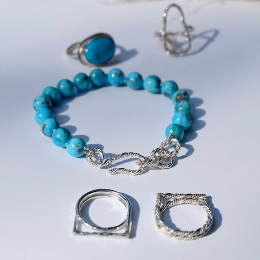 Turquoise bead bracelet showcasing sterling silver details