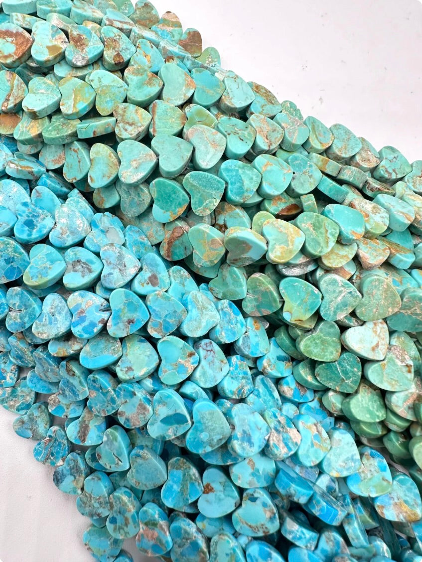 Turquoise heart-shaped stones on a white background