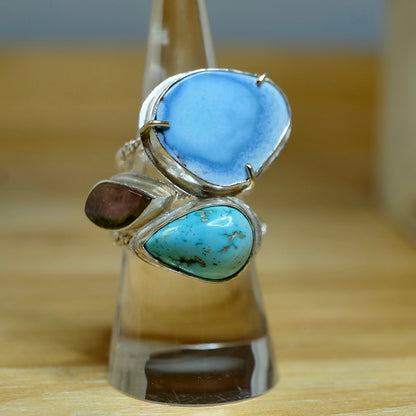 A collection of turquoise rings artistically arranged, showcasing vibrant blue hues and unique patterns.