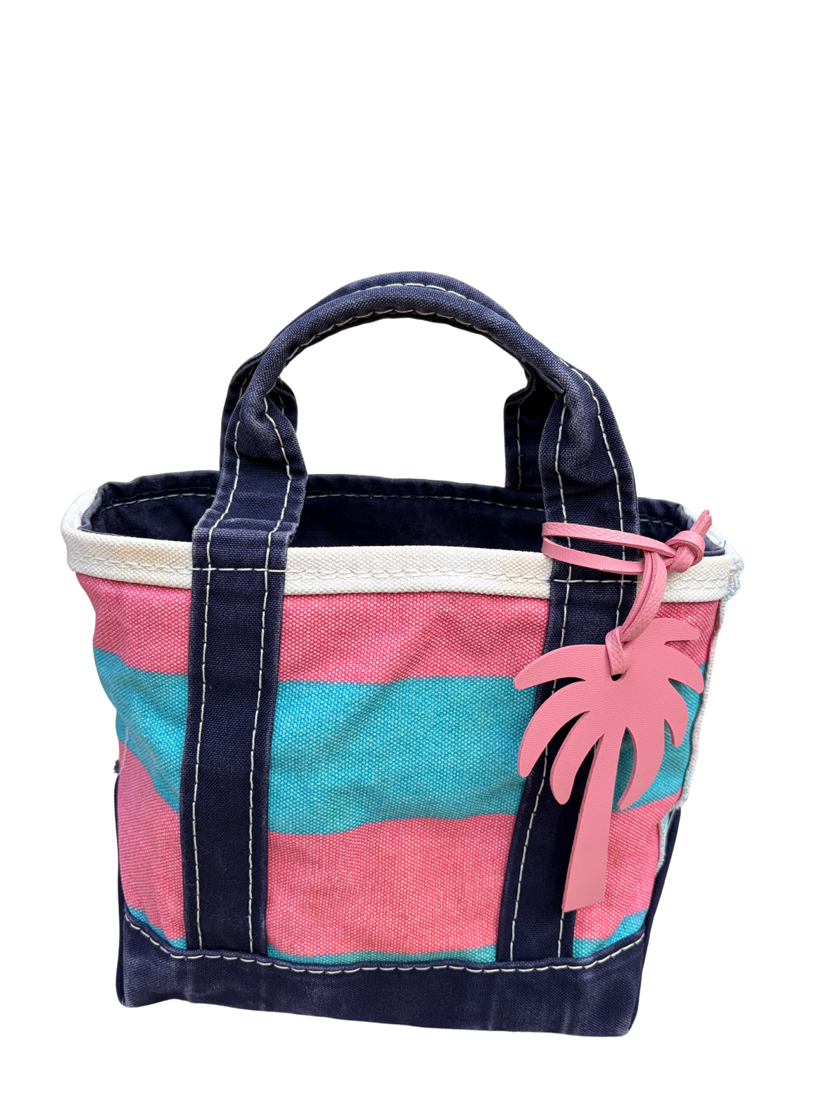 Close-up of the vintage blue and pink rugby stripe L.L. Bean mini bag displaying the included palm tree bag charm.