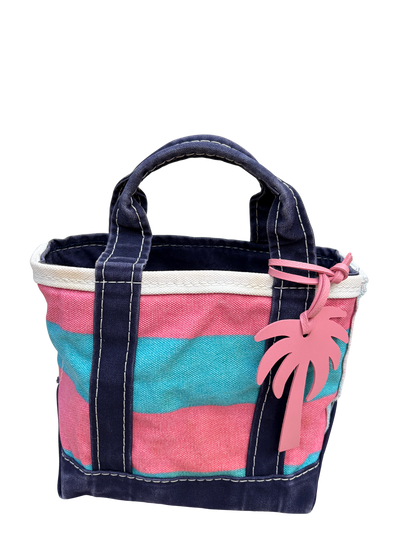 Close-up of the vintage blue and pink rugby stripe L.L. Bean mini bag displaying the included palm tree bag charm.