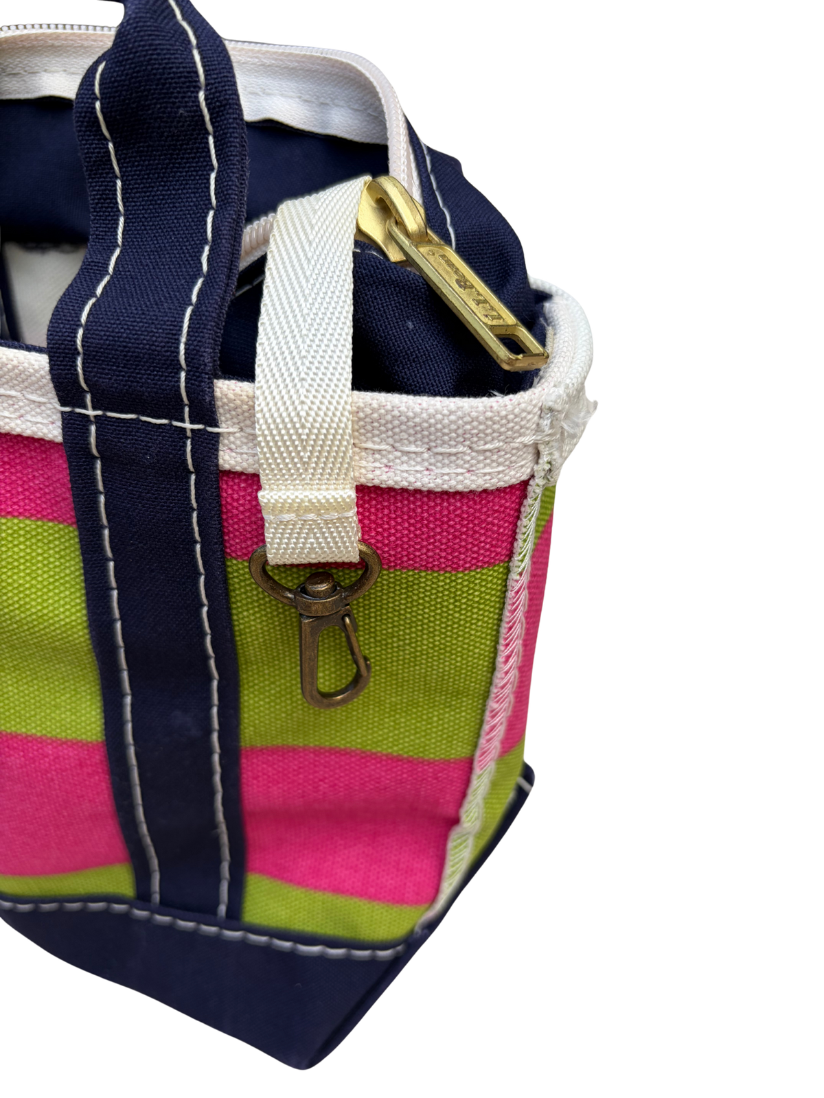 Side profile view of the vintage L.L. Bean mini canvas bag showing the alignment of the pink and green rugby stripe pattern along the side seams.