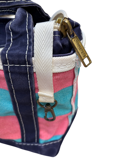 Side profile view of the vintage blue and pink rugby stripe L.L. Bean mini heavy canvas bag showing side seams and handles.